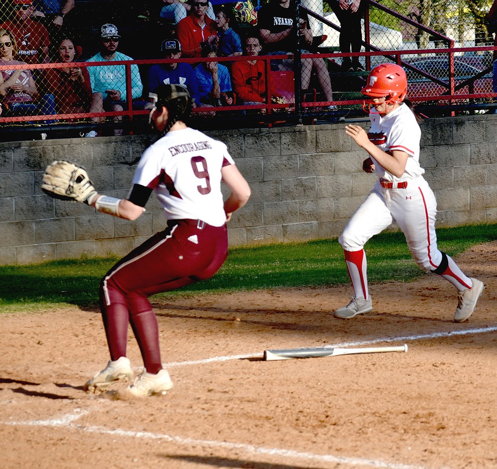 MARK HUMPHREY ENTERPRISE-LEADER/Farmington sophomore Skyler Riddle races home while Gentry pitcher Kyleigh Wheaton covers home plate on a passed ball during a fifth inning four-run rally by the Lady Cardinals, who were down 6-1 when the rally began.