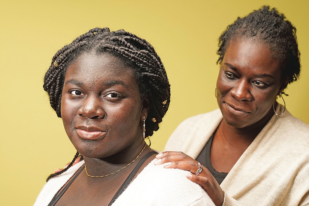Ebele Azikiwe, 12, poses for a photo with her mother, Rume Joy Azikiwe-Oyeyemi, in Cherry Hill, N.J., Wednesday, March 24, 2021. Ebele testified in October at state Assembly hearing, lending her support to legislation requiring New Jersey's school districts to add diversity to curriculums. Democratic Gov. Phil Murphy signed the bill into law. (AP Photo/Matt Rourke)