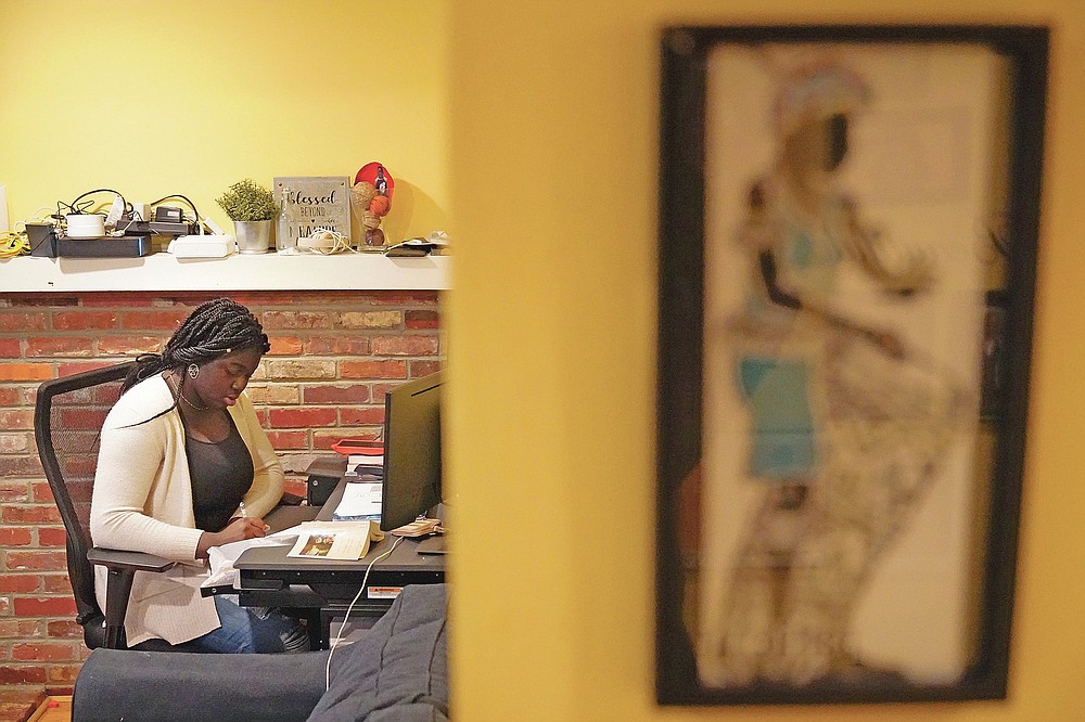 Ebele Azikiwe, 12, writes at her desk at home in Cherry Hill, N.J., Wednesday, March 24, 2021. Azikiwe testified in October at a state Assembly hearing, lending her support to legislation requiring New Jersey's school districts to add diversity to curriculums. Democratic Gov. Phil Murphy signed the bill into law. (AP Photo/Matt Rourke)
