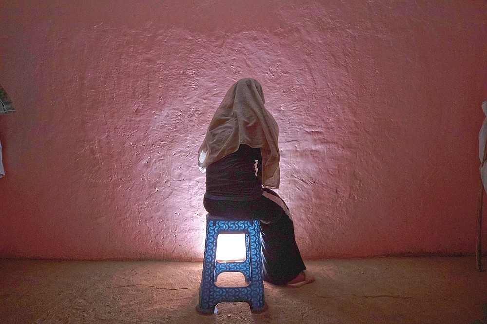 A Tigrayan refugee rape victim who fled the conflict in Ethiopia's Tigray sits for a portrait in eastern Sudan near the Sudan-Ethiopia border, on March 20, 2021. Several refugees from different Tigray communities told the AP they watched or listened helplessly as women were taken away by Amhara or Eritrean fighters and raped. (AP Photo/Nariman El-Mofty)