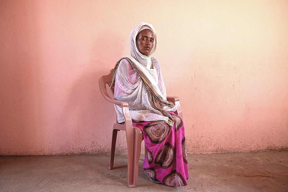 Tigrayan refugee Alem Mebrahtu, 30, who fled the conflict in Ethiopia's Tigray, sits for a portrait in eastern Sudan, near the border with Ethiopia, on March 15, 2021. Bodies were strewn near the riverbank, she said. "Some were face-down. Some were looking up at the sky." She estimated some 50 corpses. (AP Photo/Nariman El-Mofty)