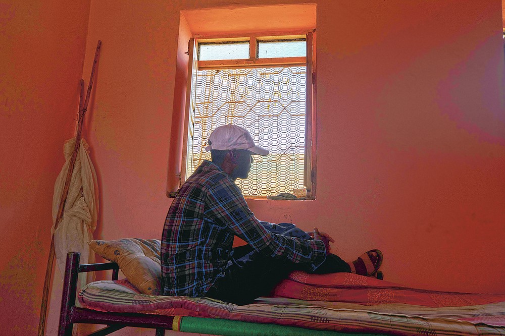 Tigrayan refugee Kidu Gebregirgis, a farmer who fled the conflict in Ethiopia's Tigray, is photographed in eastern Sudan, near the border with Ethiopia, on March 15, 2021. Gebregirgis said he was questioned almost daily about his ethnicity, his shirt yanked aside to check for marks from the strap of a gun. He said the Amhara harvested some 5,000 kilograms (5.5 tons) of sorghum from his fields and hauled it away. The task took two weeks to complete. He never tried to stop them. (AP Photo/Nariman El-Mofty)