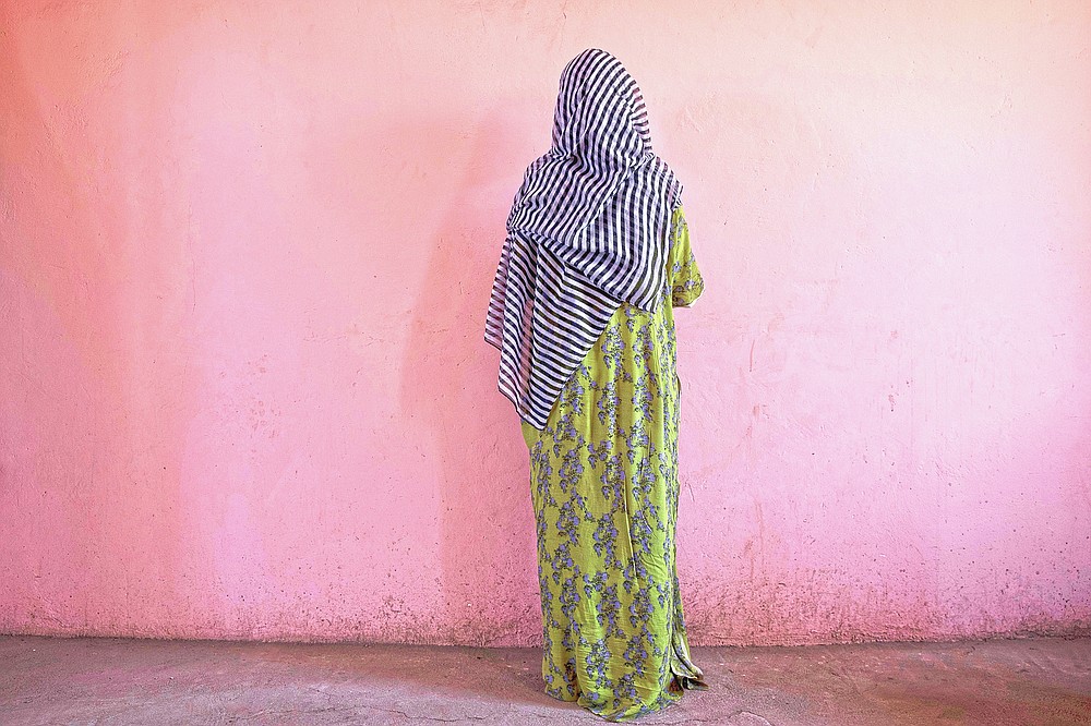 A Tigrayan woman who says she was gang raped by Amhara fighters, stands for a portrait in eastern Sudan, near the border with Ethiopia, on March 23, 2021. "Let the Tigray government come and help you," she recalled them saying, even while they were raping her. (AP Photo/Nariman El-Mofty)