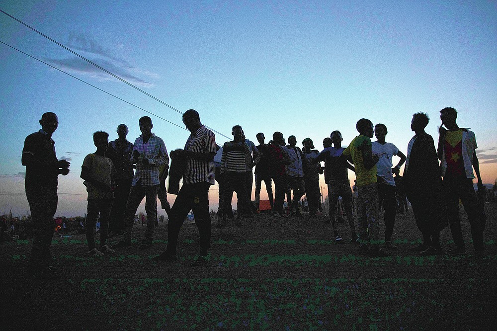 Tigrayan refugees who fled the conflict in the Ethiopia's Tigray gather after the sun sets in Hamdayet, eastern Sudan, near the border with Ethiopia, on March 23, 2021. For months, it has been the Tigrayans' word against that of the government in Ethiopia, Africa's second most populous country and one of its most powerful. But now, for the first time, there is official proof of what is being called ethnic cleansing in the form of identity cards smuggled across the border into this Sudanese border post and confirmed to The Associated Press by more than a half-dozen refugees from different communities. (AP Photo/Nariman El-Mofty)