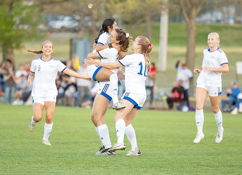 Photo courtesy of Karen Penner/JBU Sports Information
John Brown's Vanessa Reynoso jumps into the arms of Audrey Balafas as teammates Aubrey Mendez, left, Sienna Carballo, No. 10 and Paige Kula, right, join in after Reynoso scored on a free kick to tie Thursday's Sooner Athletic Conference Tournament championship at 1-1 in the first half. JBU went on to defeat Science and Arts 5-1.