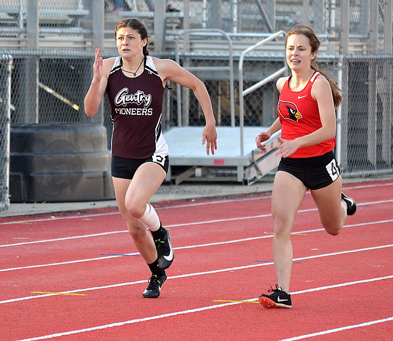 Westside Eagle Observer/ANNETTE BEARD
Gentry's Maci Hubbard (left) focuses on the finish line in a running event at the track meet in Pea Ridge on Thursday, March 8, 2021. She took first in the 400-meter run and third in the 200-meter dash at the meet.