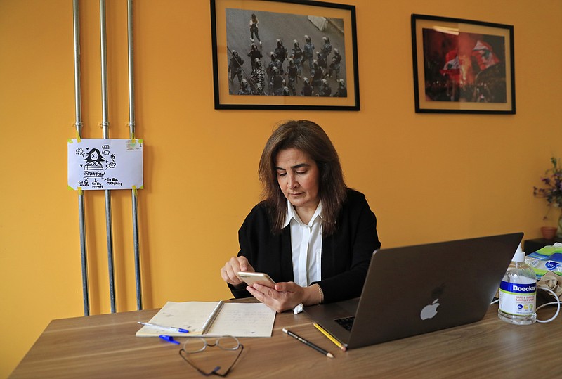 Diana Moukalled, a Lebanese journalist who closely follows social media, checks the Clubhouse application at her office in Beirut, Lebanon, on Wednesday. Hundreds of thousands of people in the Arab world are turning to Clubhouse, the fast-growing audio chat app, to mock and vent against longtime rulers, and debate sensitive issues from abortion to sexual harassment. But concerns are mounting that the open space could quickly come under the same government surveillance or censorship as other social media. - AP Photo/Hussein Malla
