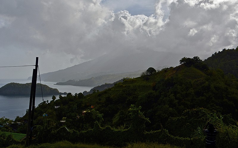 Ash rises into the air as La Soufriere volcano erupts on the eastern Caribbean island of St. Vincent, seen from Chateaubelair, Friday, April 9, 2021. (AP Photo/Orvil Samuel)