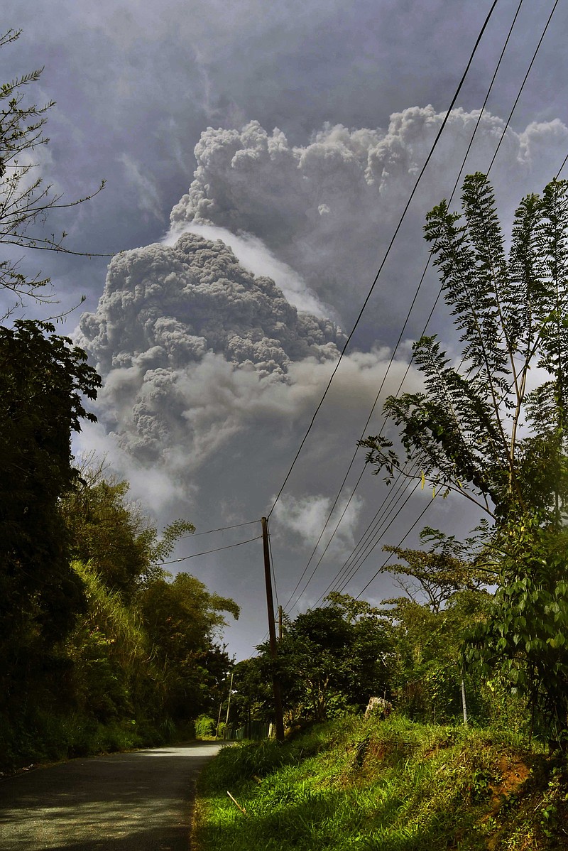 Plumes of ash rise from the La Soufriere volcano as it erupts on the eastern Caribbean island of St. Vincent, as seen from Chateaubelair, Friday. - AP Photo/Orvil Samuel
