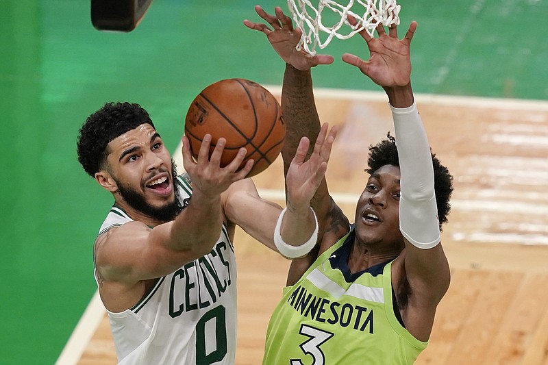 Boston Celtics forward Jayson Tatum (0) goes to the basket against Minnesota Timberwolves forward Jaden McDaniels (3) during the second quarter of Friday's game in Boston. - Photo by Elise Amendola of The Associated Press