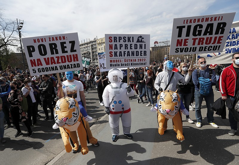 People attends a protest in front of the Serbian Parliament building in Belgrade, Serbia, Saturday, April 10, 2021. Environmental activists are protesting against worsening environmental situation in Serbia. (AP Photo/Darko Vojinovic)