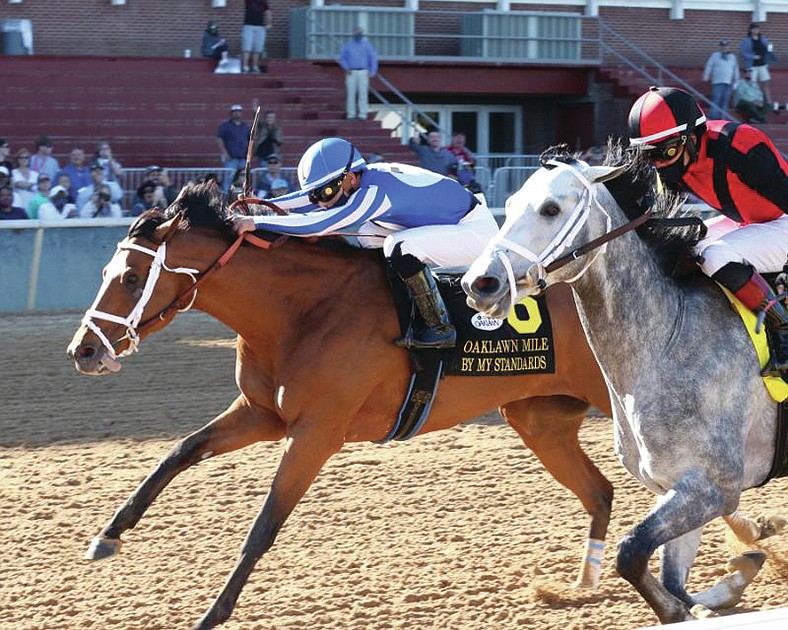 By My Standards, under jockey Gabriel Saez, noses past Rushie to win the Oaklawn Mile Saturday at Oaklawn. - Photo courtesy of Coady Photography