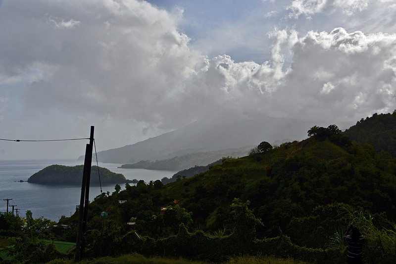 Ash rises into the air as La Soufriere volcano erupts on the eastern Caribbean island of St. Vincent, seen from Chateaubelair, Friday, April 9, 2021. (AP Photo/Orvil Samuel)