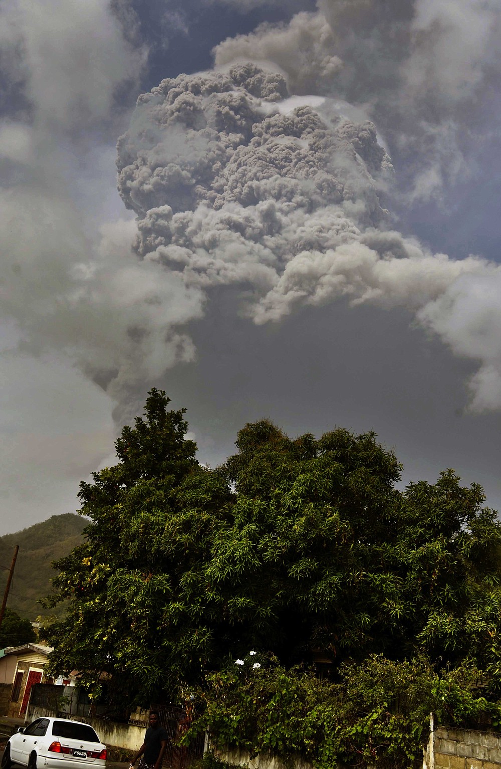 Plumes of ash rise from the La Soufriere volcano as it erupts on the eastern Caribbean island of St. Vincent, as seen from Chateaubelair, Friday, April 9, 2021. (AP Photo/Orvil Samuel)