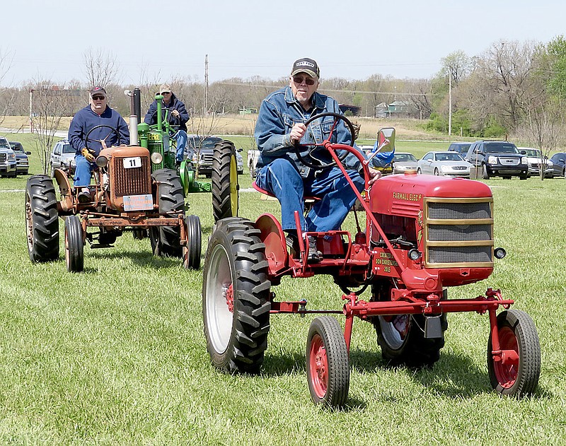 Westside Eagle Observer/RANDY MOLL
Don Christensen of Gentry drives an electric tractor during the parade of power at noon on Friday, April 20, 2018, at the spring show of the Tired Iron of the Ozarks in Gentry. He converted the 1949 Farmall Cub to an electric-powered tractor in 2015 and has entered it in the show and numerous parades.