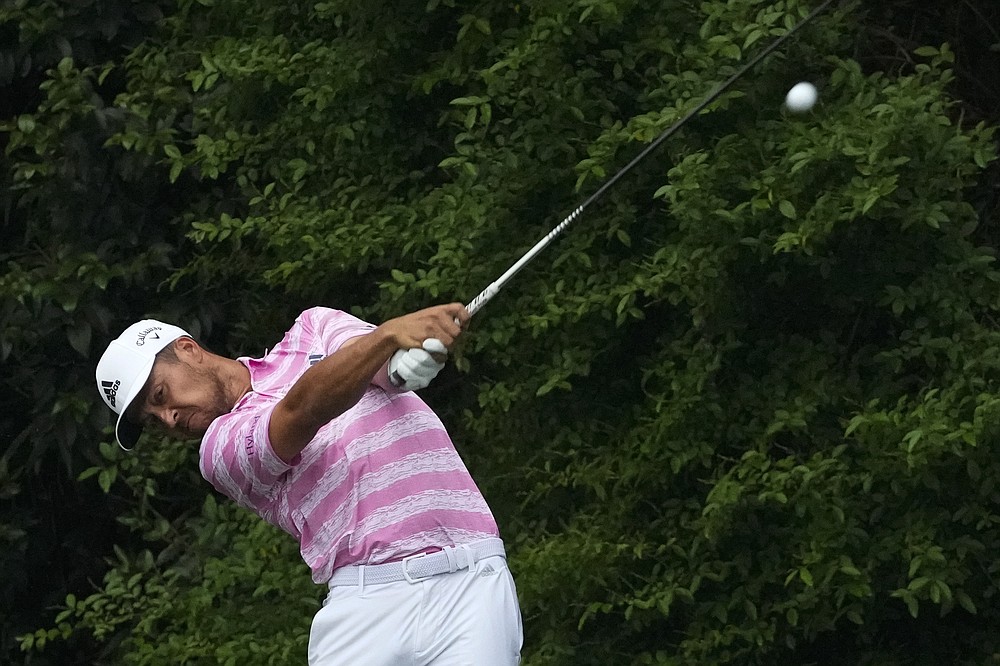 Xander Schauffele tees off on the 14th hole during the third round of the Masters golf tournament on Saturday, April 10, 2021, in Augusta, Ga. (AP Photo/Charlie Riedel)