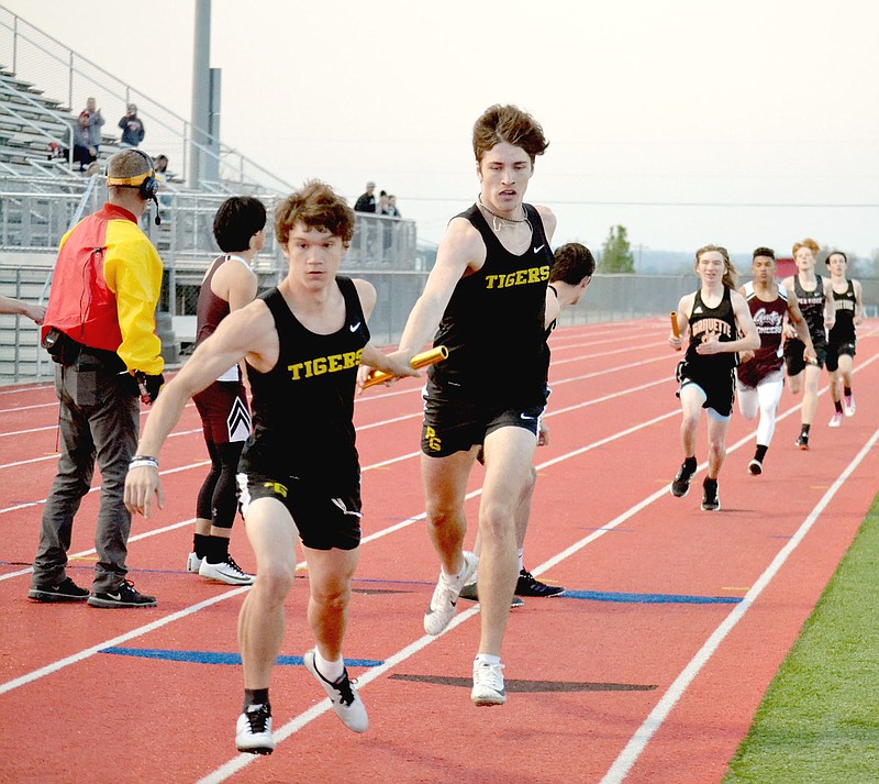 Annette Beard Special to the Enterprise-Leader/Prairie Grove junior Landon Semrad hands off the baton to teammate Wyatt Young during the boys 4x400 relay at Blackhawk Relays hosted by Pea Ridge on Thursday. Prairie Grove finished fifth in the 4x400 with a time of 3:55.38. Also running legs of the race were Coner Whetsell and Zeke McDonald.