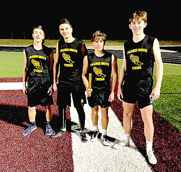 Submitted photo/The Prairie Grove junior high boys 4x400 relay team (from left): Mark Stucki, seventh grader; Cole Ashley, ninth grader; Tate Cox, eighth grader; and Cole Edmiston, ninth grader; won the event at the Wolf Relays hosted by Lincoln on Wednesday, March 30 at Wolfpack Stadium. The junior Tigers finished third overall in the team standings.