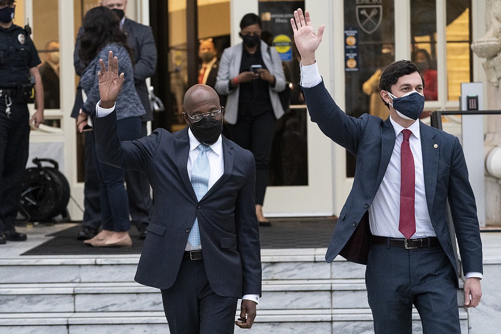 Sen. Raphael Warnock, D-Ga., Sen. Jon Ossoff, D-Ga., wave to the crowd after speaking with President Joe Biden and Vice President Kamala Harris during an event at Emory University, Friday, March 19, 2021, in Atlanta. (AP Photo/Alex Brandon)