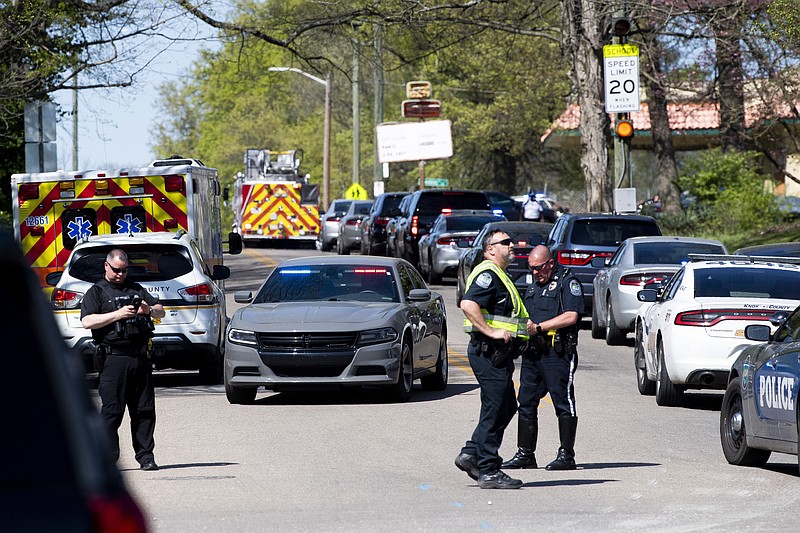 Police work in the area of Austin-East Magnet High School after a reported shooting Monday, April 12, 2021. Authorities say multiple people including a police officer have been shot at the school. (Brianna Paciorka/Knoxville News Sentinel via AP)