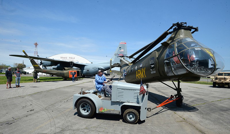 Jeff Gates, a longtime volunteer, uses a tug Tuesday to position a Piasecki H-21 Workhorse/Shawnee helicopter into position beside a Bell UH-1 Iriquois as he and other volunteers and staff members prepare for this weekendճ Warbird Weekend at the Arkansas Air and Military Museum in Fayetteville. The Boeing B-29 Superfortress will be joined by a North American T-28 Trojan and a Ryan PT-22 Recruit will be on hand for tours and flights Friday through Sunday at the museum. 
(NWA Democrat-Gazette/Andy Shupe)