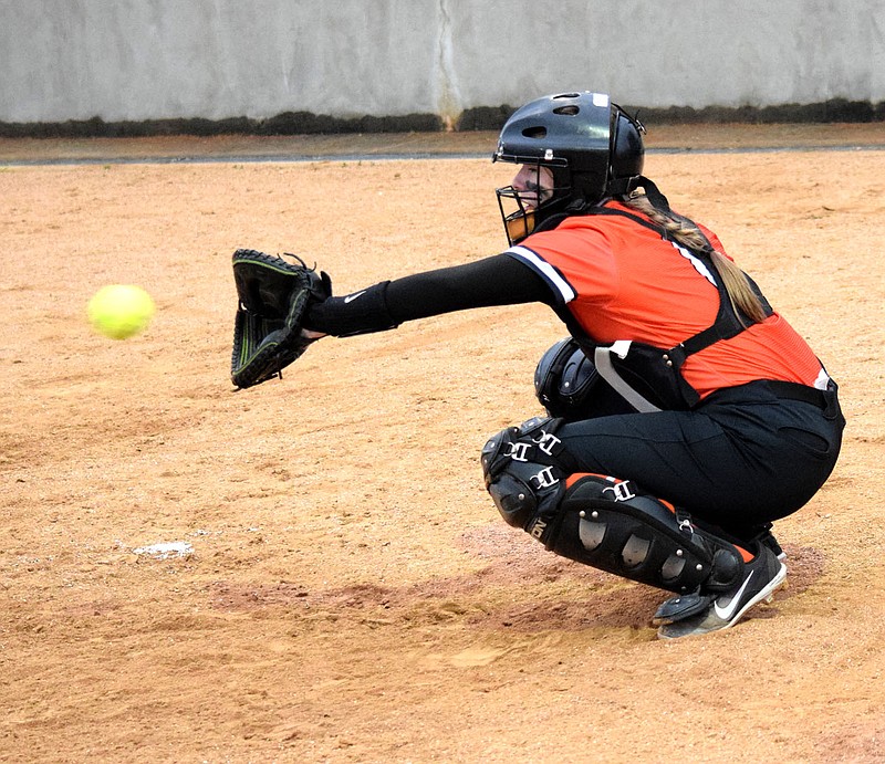 Westside Eagle Observer/MIKE ECKELS
Kelsey Pembleton catches a pitch from Brooke Handle during warmups prior to the start of the Gravette-Springdale softball game at Lion softball field in Gravette March 12.  In a game played April 15 in Clarksville, Pembleton led the Lady Lions with three hits and one run in the 10-7 loss to the Lady Panthers.