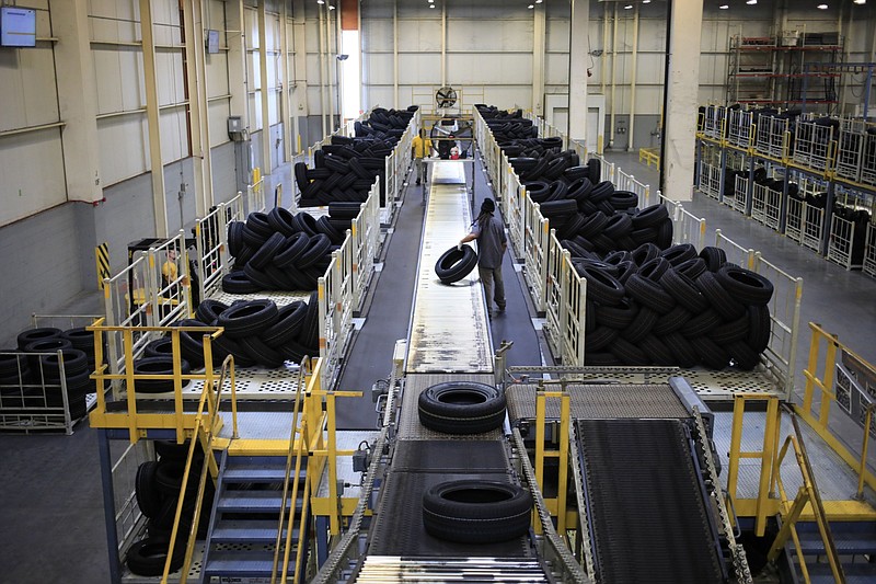 A worker unloads automotive tires at a facility in Sumter, S.C. on March 23, 2021. MUST CREDIT: Bloomberg photo by Luke Sharrett.