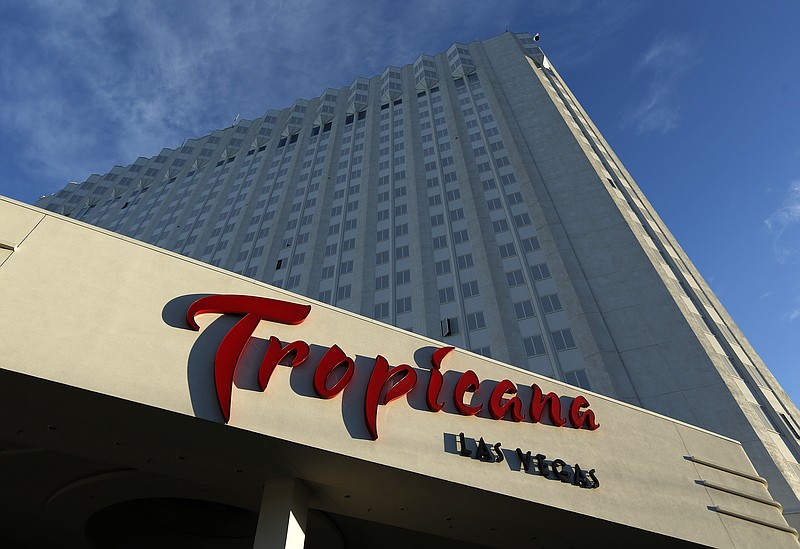 FILE - In this Aug. 4, 2015, file photo, sunlight illuminates a sign at the Tropicana hotel and casino in Las Vegas.  The Tropicana Las Vegas Hotel and Casino is being sold. Bally’s Corp. announced Tuesday, April 13, 2021,  it will acquire the iconic Las Vegas Strip property from Gaming and Leisure Properties Inc. for about $308 million.(AP Photo/John Locher,File)