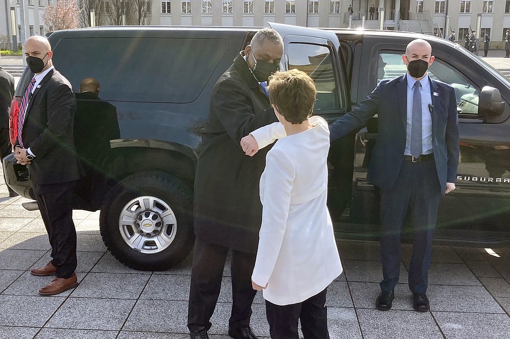 U.S. Defense Secretary Lloyd Austin is greeted by German Defense Minister Annegret Kano-Karrenbauer, Tuesday, April 13, 2021, in Berlin. (AP Photos/Robert Burns)