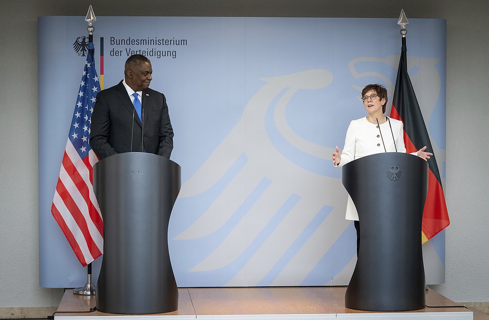 Annegret Kramp-Karrenbauer, Federal Minister of Defence, and US Secretary of Defence Lloyd Austin attend a news conference at the Federal Ministry of Defence in Berlin, Germany, Tuesday, April 13, 2021. This is the first visit to Germany by a minister of the new US administration. Austin will then travel on to Stuttgart, where he will talk to soldiers at the US command centres for troops in Africa and Europe. (Kay Nietfeld/dpa via AP)