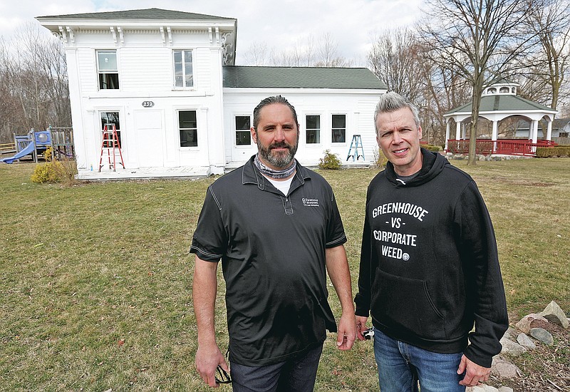 From left, Darin Dell, owner of Especially Windows and Remodeling and Jerry Millen, owner of Greenhouse of Walled Lake partnered to get new windows installed at the Banks-Dolbeer-Bradley-Foster Farmhouse in Walled Lake, Mich on Wednesday, March 24, 2021. The home was an Underground Railroad stop for slaves to get food and a place to rest during their escape. (Eric Seals /Detroit Free Press via AP)