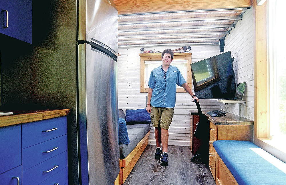 Vicksburg native David Osburn poses in the 221-square foot tiny house he designed and built as a teenager in Vicksburg, Miss., on Wednesday, July 22, 2020. (Courtland Wells/The Vicksburg Post via AP)