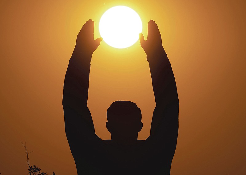 FILE - In this Saturday, Sept. 21, 2019 file photo, the sun sets over a statue of the first cosmonaut Yuri Gagarin at the Russian leased Baikonur cosmodrome in Kazakhstan. From a giant statue towering over Moscow to a more modest monument on the Sakhalin Island in the Pacific Ocean, dozens of memorials across Russia commemorate Yuri Gagarin, the cosmonaut who became the first person in space on April 12, 1961, 60 years ago. (AP Photo/Dmitri Lovetsky, File)