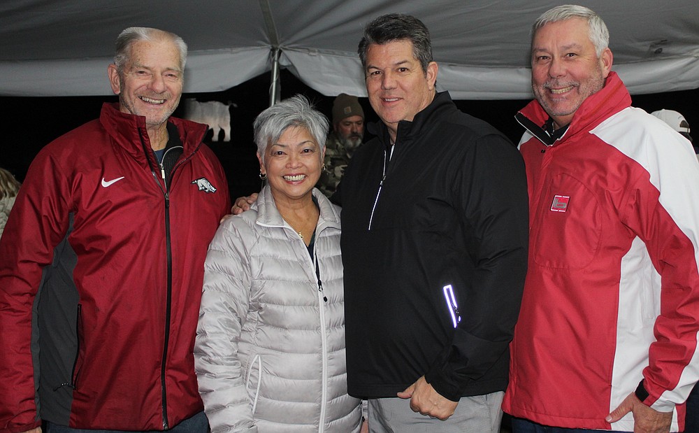 NWA Democrat-Gazette/CARIN SCHOPPMEYER Norm and Caroline DeBriyn, Tom Pagnozzie and Gary Head welcome Pagnozzi Charities patrons for the 27th annual Ultimate Tailgate and Auction on Nov. 2 at Stonebridge Meadows Golf Club in Fayetteville.