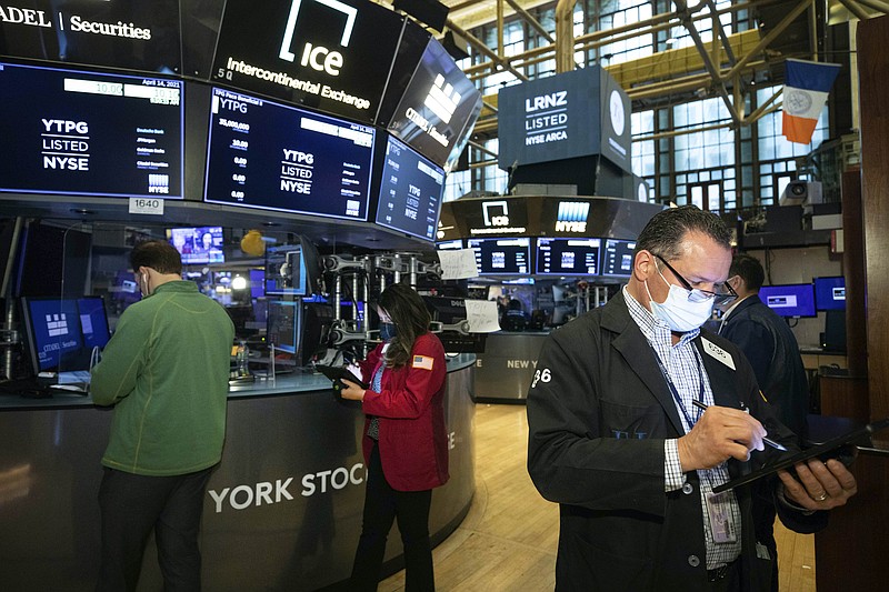 In this photo provided by the New York Stock Exchange, traders work on the floor, Wednesday April 14, 2021. U.S. stock indexes are tacking a bit more onto their record highs in midday trading Wednesday after big banks kicked off a highly anticipated earnings reporting season with profits that thundered past Wall Street's expectations. (Colin Ziemer/New York Stock Exchange via AP)