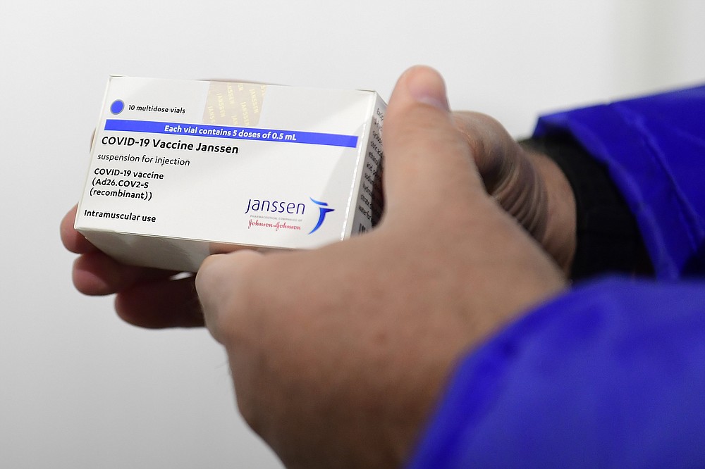 FILE - In this April 13, 2021, file photo, a box of Johnson & Johnson vaccines are shown by pharmacist Zsolt Szenasi at a warehouse of Hungaropharma, a Hungarian pharmaceutical wholesale company, in Budapest, Hungary. European nations are scrambling Wednesday, April 14, in the wake of Johnson & Johnson’s decision to delay the rollout of its COVID-19 vaccine amid reports of rare blood clots. (Szilard Koszticsak/MTI via AP, File)
