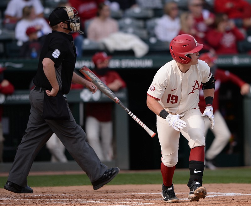 Arkansas designated hitter Charlie Welch watches Wednesday as a two-run home run leaves the field during the third inning of the Razorbacks' 26-1 win over UAPB at Baum-Walker Stadium in Fayetteville. - Photo by Andy Shupe of NWA Democrat-Gazette