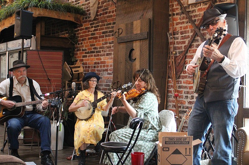 From left, Tom Sartain, Jenny Sartain, Judy Warner and Charlie Moore, the Arkansas Highlands String Band, perform at Crystal Ridge Distillery on Wednesday, April 14. It was the first time any of them have performed in front of a live audience in over a year. - Photo by Tanner Newton of The Sentinel-Record