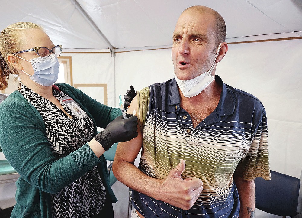Melissa Mason gives Kenny Collins a COVID-19 vaccination at the Fourth Street Clinic in Salt Lake City on March 23, 2021. Homeless Americans who have been left off priority lists for coronavirus vaccinations β or even bumped aside as states shifted eligibility to older age groups β are finally getting their shots as vaccine supplies increase. (Jeffrey D. Allred/The Deseret News via AP)