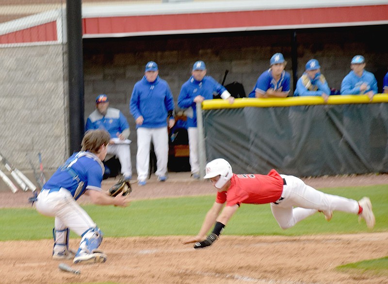 MARK HUMPHREY  ENTERPRISE-LEADER/Farmington's Trey Hill dives into a slide while attempting to score a go-ahead run at the bottom of the sixth inning. He was ruled out on the play after tagging up on Lawson Devault's long fly ball ending in the inning in a 2-2 deadlock. Harrison scored two runs in the seventh to post a 4-2 win, taking over first place in the 4A-1 baseball standings.