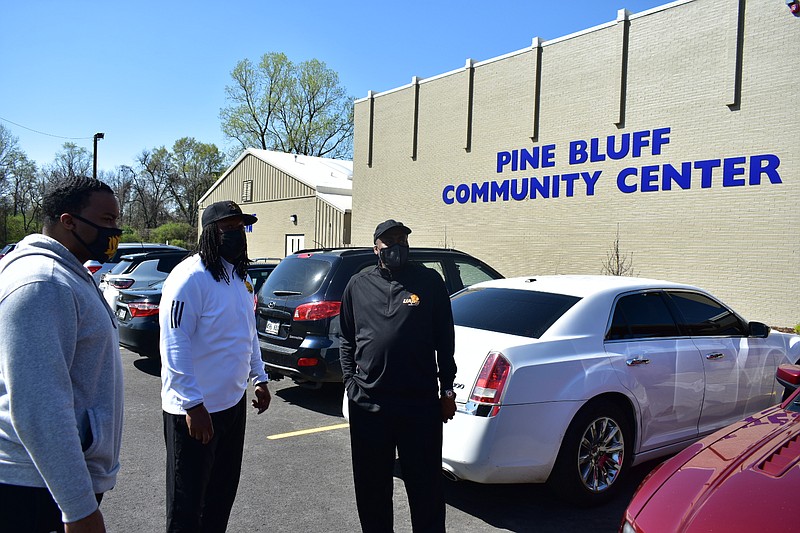 From left, UAPB men's basketball assistant coach Richard Cannon, assistant athletic director for academics Kyle Hartsfield and men's basketball head Coach George Ivory talk outside the Pine Bluff Community Center on Wednesday, March 24, 2021. (Pine Bluff Commercial/I.C. Murrell)