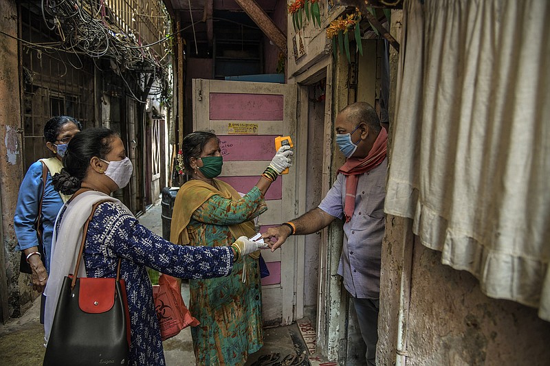 HealHealth workers conduct blood oxygen and body temperature checks Thursday in Mumbai, India, while doing contact tracing. Stringent restrictions have been imposed in Mumbai and New Delhi. More photos at arkansasonline.com/416covid/.
(The New York Times/Atul Loke)