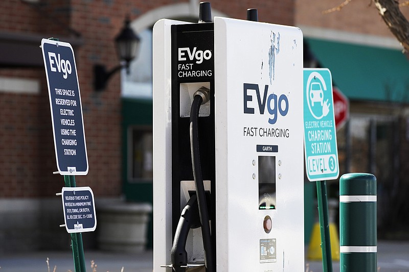 FILE - This March 31, 2021 file photo shows a EVgo electric vehicle charging station  at Willow Festival shopping plaza parking lot in Northbrook, Ill.    The European Union is lacking sufficient charging infrastructure for electric vehicles, according to the bloc's external auditor. In a report published Tuesday, April 13, 2021, the European Court of Auditors said users are gaining more harmonized access to charging networks but the EU is still “a long way from reaching its Green Deal target of 1 million charging points by 2025."  (AP Photo/Nam Y. Huh, File)