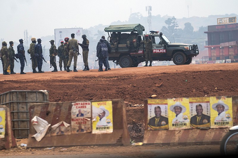 FILE - In this Thursday, Jan. 14, 2021 file photo, security forces gather on election day in Kampala, Uganda. The United States said Friday, April 16, 2021 that it is imposing visa restrictions on "those believed to be responsible for, or complicit in, undermining the democratic process in Uganda," including during the election in January and the campaign period. (AP Photo/Jerome Delay, File)