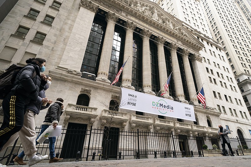 FILE - Pedestrians pass the New York Stock Exchange, Wednesday, Jan. 27, 2021, in New York. Stocks are opening higher on Wall Street, keeping the S&P 500 on track for its fourth weekly gain in a row. The benchmark index was up 0.3% in the early going Friday, April 16, led by gains in banks, industrial and health care companies.  (AP Photo/John Minchillo, File)