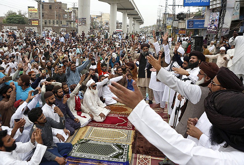 Supporters of the radical Tehreek-e-Labiak Pakistan Islamist political party chant and hold a sit-in  protest Friday in Lahore over the arrest of their party leader, Saad Rizvi, and to demand the expulsion of France’s envoy in response to cartoons they consider blasphemous. 
(AP/K.M. Chaudary)