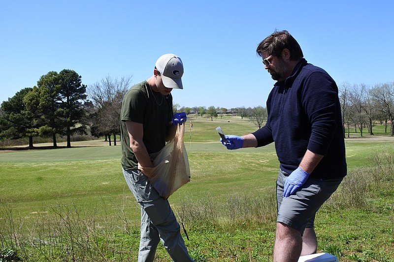 Ethan Moore, junior and biology major at the University of Arkansas at Fort Smith, left, and Jeff Shaver, associate professor of biological sciences at the College of Science, Technology, Engineering and Mathematics at UAFS, right, take a soil sample in one of the restored areas at Ben Geren Golf Course on March 29. 
(NWA Democrat-Gazette/Thomas Saccente)