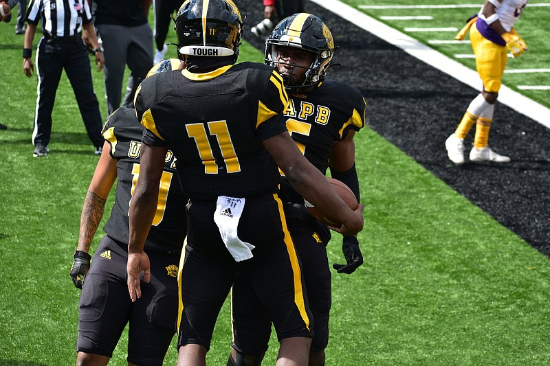 UAPB quarterback Skyler Perry (11) chest-bumps tight end Jeremy Brown (6) after a 1-yard rushing touchdown against Prairie View A&M on Saturday at Simmons Bank Field. (Pine Bluff Commercial/I.C. Murrell)