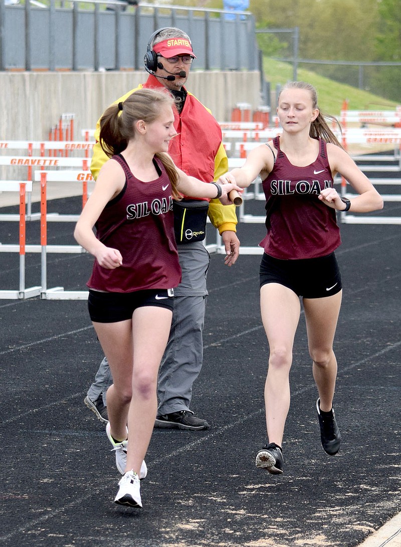 Mike Eckels/Westside Eagle Observer
Siloam Springs girls track runners hand off the baton during a relay Thursday at the Gravette Lion Invitational.