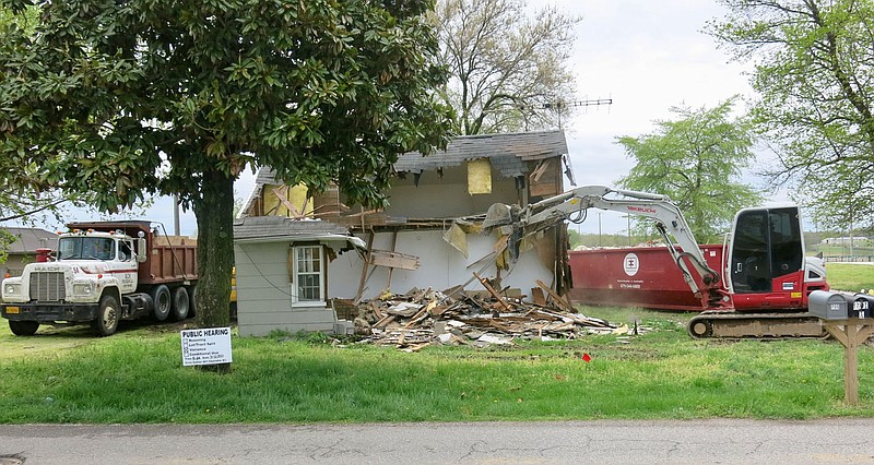 Westside Eagle Observer/SUSAN HOLLAND
Workmen are busy Wednesday afternoon, April 14, demolishing and hauling off debris from a house on Dallas Street S.W. in Gravette. The lot was completely clear the next day. Appropriately enough, the work was done during Gravette's annual spring cleanup week. A public hearing was held on the property, just east of Pop Allum Park, on April 6. A developer has plans to build three new single family homes on the lot.